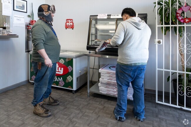 An employee gets a pizza order for his customer at Big Al's Pizza in Sun Village.