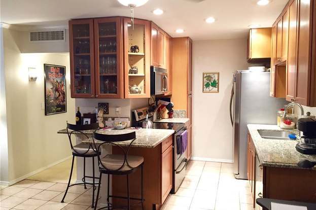 Remodeled kitchen with extended granite countertops and cupboards