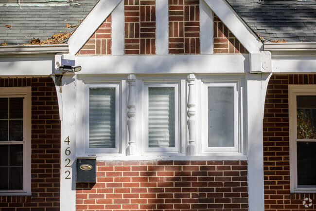 A Tudor home that has detailed brick work and inlaid column carvings in Hunting Ridge.
