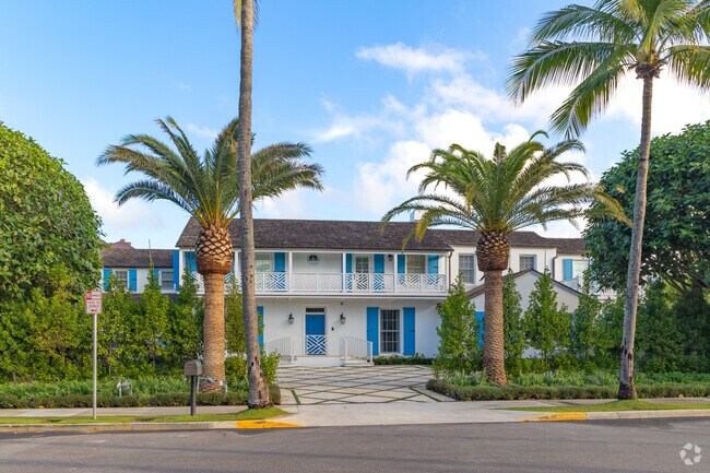 Palm trees frame this coastal home in Palm Beach.