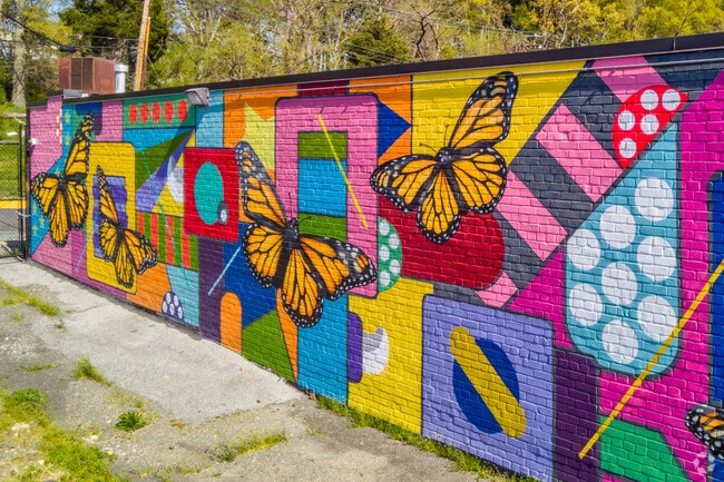 Residents admire colorful murals featuring monarch butterflies in Lewisdale.