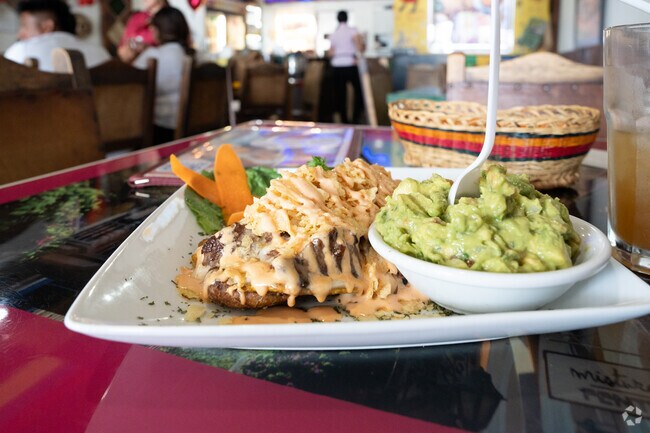 Bandeja Paisa offers delicious Colombian cuisine offering delights like a Pataconaso.