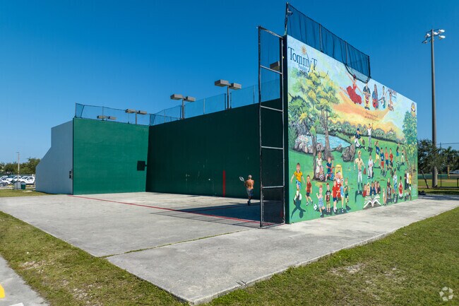 A tennis wall at Westland Gardens Park features a beautiful mural in Hialeah Gardens.