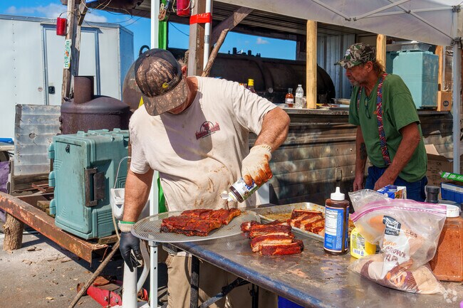 A local chef seasons his ribs in Davenport during the Community BBQ Event.