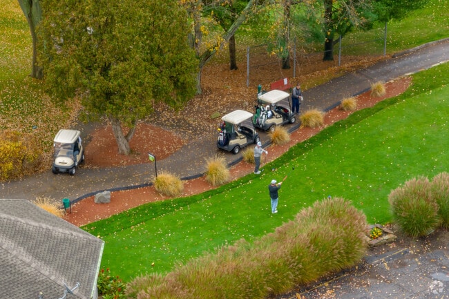 A couple of players practice swings with the team at Turkeyfoot Lake Golf Links in New Franklin.
