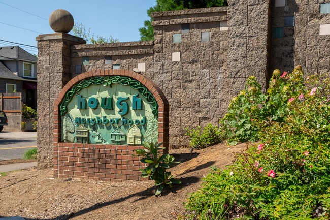 A handcrafted ceramic and brick sign marks the Hough neighborhood.