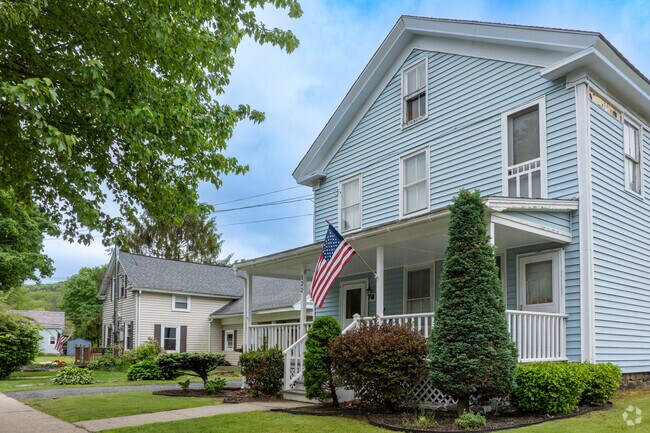 Stately homes line the gently sloping hills within the Cheshire neighborhood.