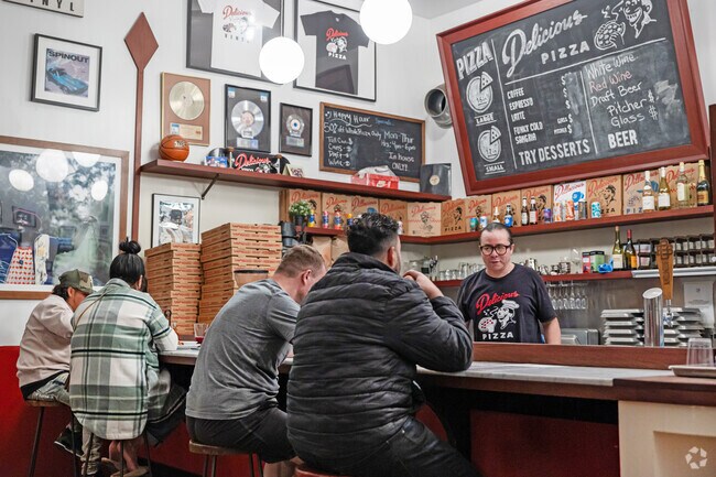 Try a slice of pizza and a cold beer at Delicious Pizza, a hip hop themed joint in West Adams.