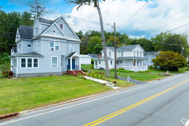 Porches and sidewalks reflect village charm near Blairstown amenities.