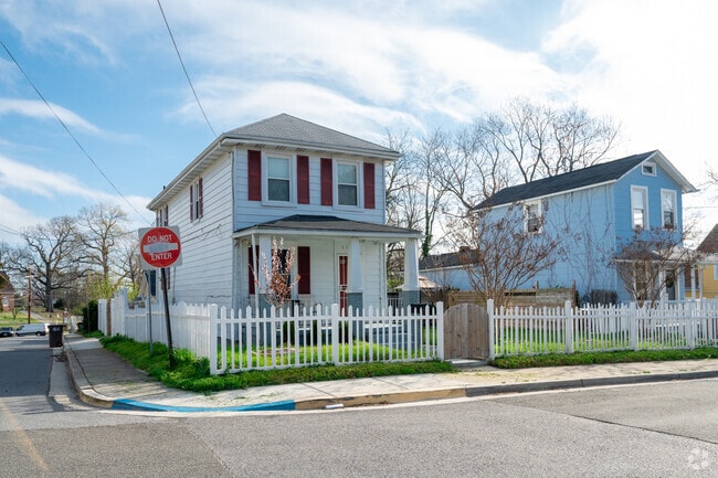 pretty two-story homes with white picket fences