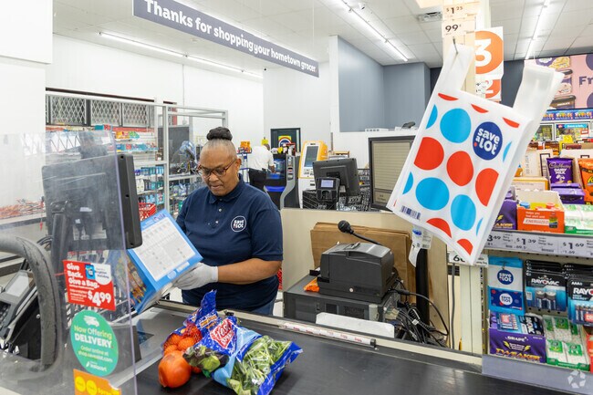 A grocery Checker at Save A Lot rings up some groceries near Harlem Park