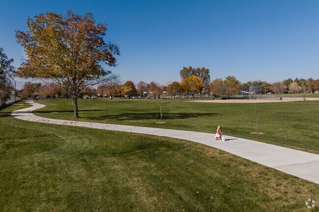 A young girl rides her bike on a path at Big Bear Park.