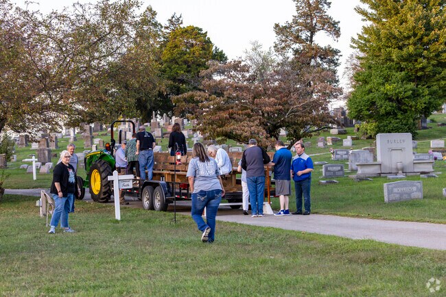 Participants of Voices of Elmwood take their seats on the trailer, taking them to each stop.
