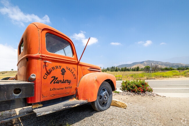 Classic farm truck seen parked in front of Cherry Valley Nursery and Landscape Supply.
