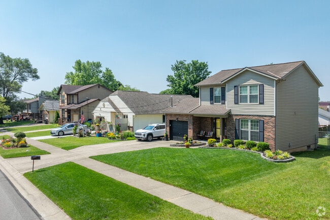 Manicured lawns and well maintained sidewalks are seen throughout the residential streets of New England Heights.