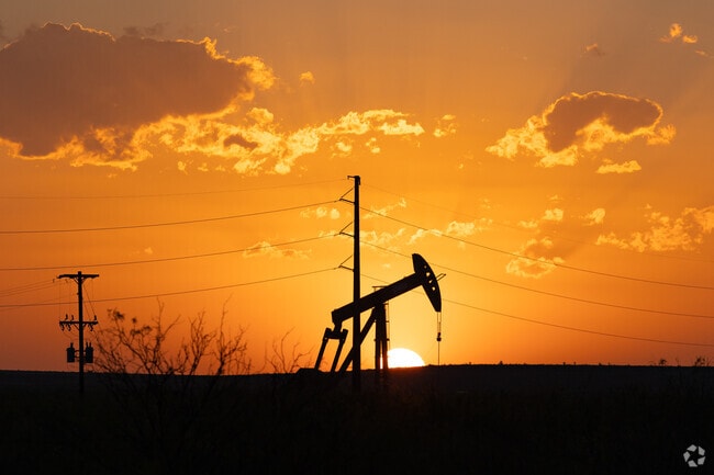 Sun setting over a long day at the oil fields of Pecos.