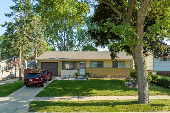 Ranch style home with mini al landscaping and attached garage in Glendale Heights.