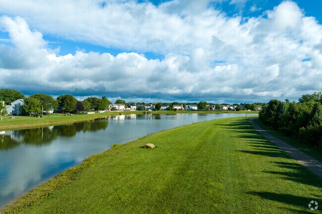 Some homes back up against a small lake.