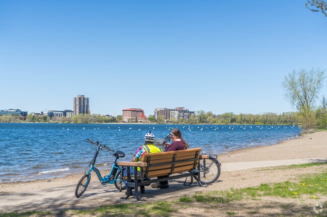 A pair of bikers take a break near the beach at Bde Maka Ska.