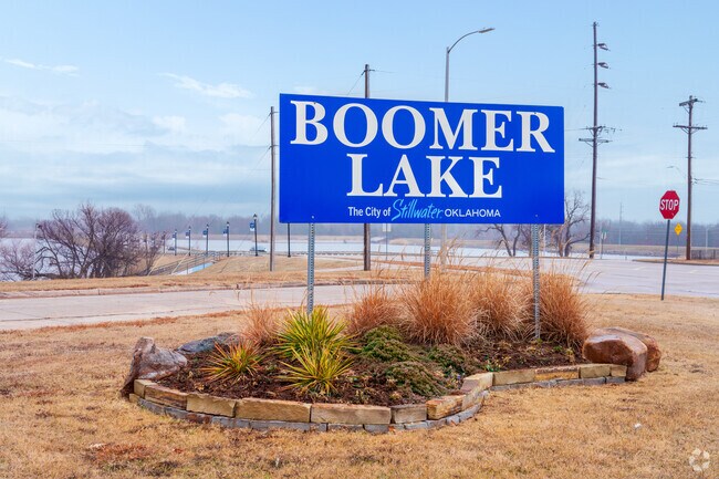 The Boomer Lake sign welcomes visitors to a peaceful retreat in Stillwater, perfect for outdoor recreation.