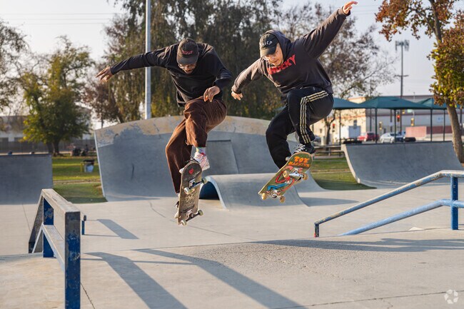 Two Southgate friends coordinate their skateboard trick at Planz Park.