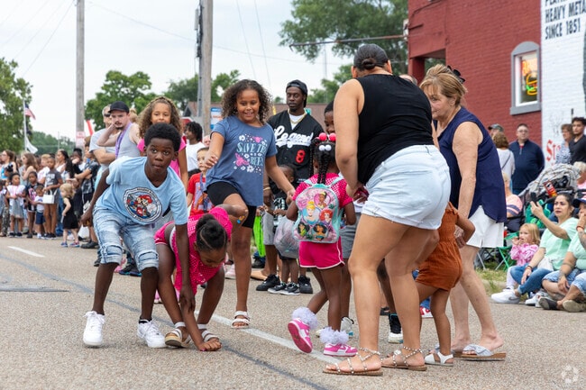 Kids dart into the streets of Piper Glen for candy during the Twilight Parade.