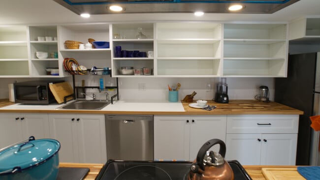 The kitchen. Lots of supplies and small appliances. Fun drainboard over the sink. Dishwasher too.