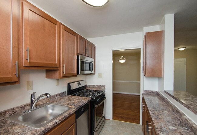 Partially renovated kitchen with stainless steel appliances