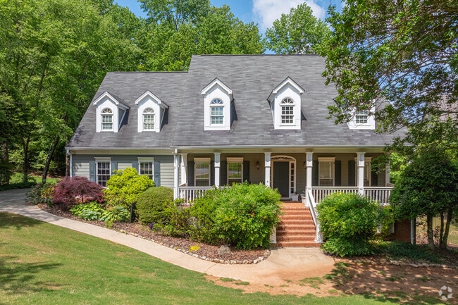 A timeless front porch and mature landscaping give this Nesbit Lakes home a warm, welcoming look.
