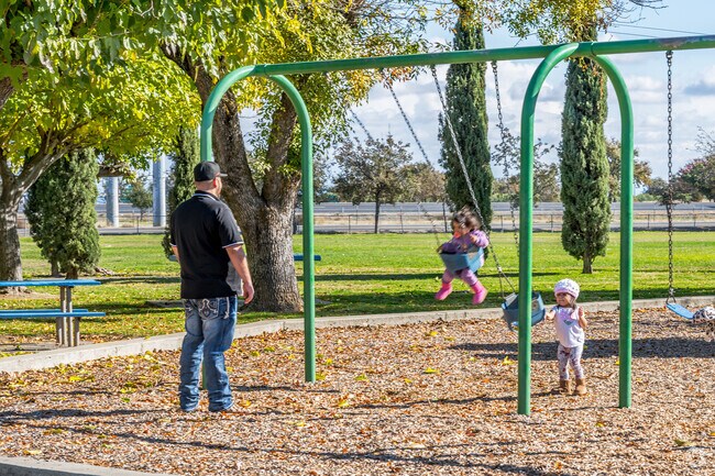 A father spends an afternoon pushing his daughter on the swings at Olivehurst’s Community Park.