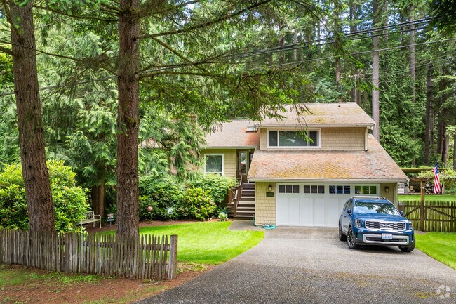 This split-level home is surrounded by fir trees in Brookside.