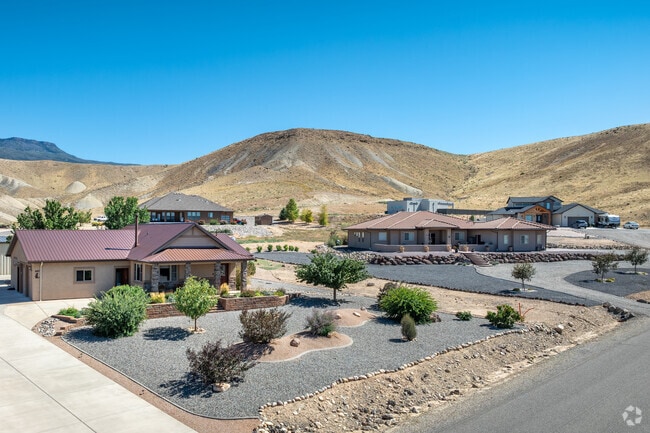 A group of modern homes sits hillside in East Orchard Mesa.