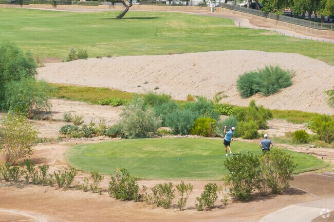 Two golfers at the Power Ranch Golf Club, a public 18-hole golf course.