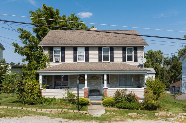 Lawrence’s streets showcase historic homes framed by towering, leafy trees.