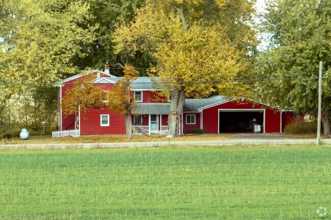 Early 1900s farmhouses sit among mature trees in Groveland.