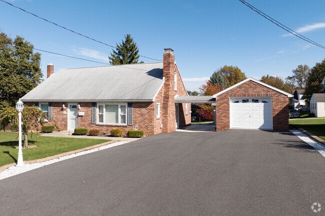 A beautiful brick Cape Cod with a detached garage in Dallastown, Pennsylvania.