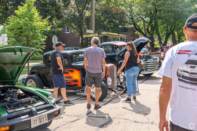 A group admires a custom hot rod at the Heritage Fest Car Show in West Dundee, near Sleepy Hollow.