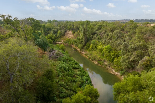 The San Antonio River flowing past River Crossing Park.