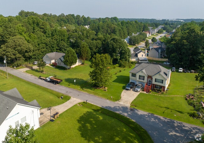 Homes sit on large acreage with green landscapes in Lake City.