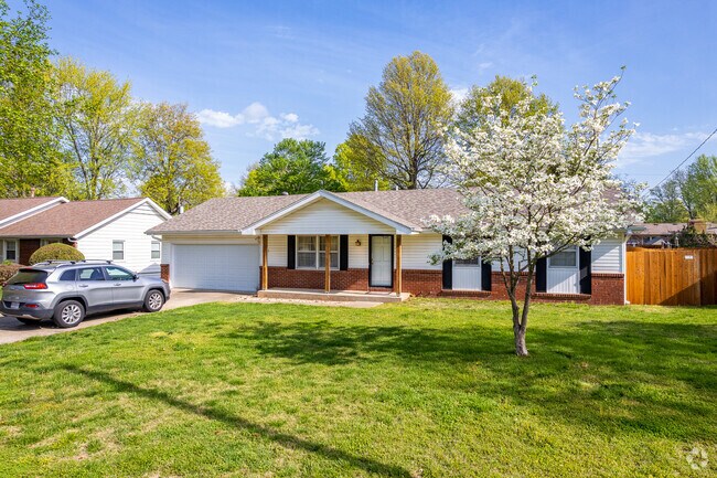 An updated ranch home in Meador Park sparkles with a blooming dogwood.
