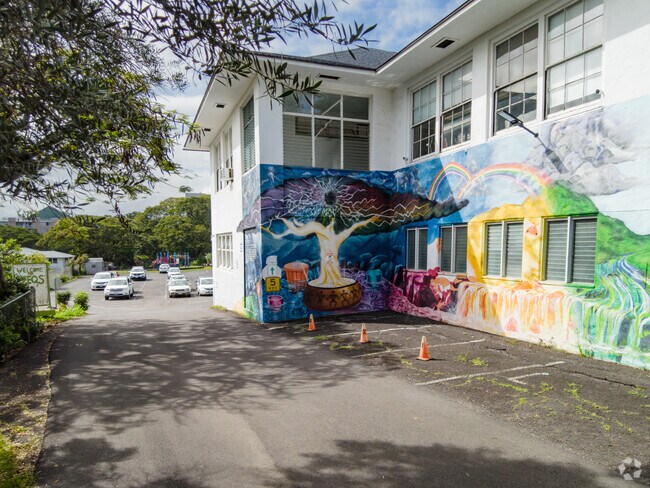 A colorful mural decorates an exterior wall at SEEQS Charter School.