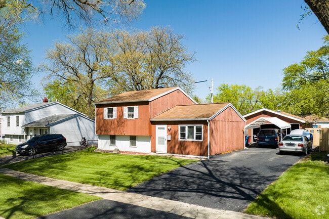 Split level homes with large front lots can be found on shaded streets in Sauk Village.