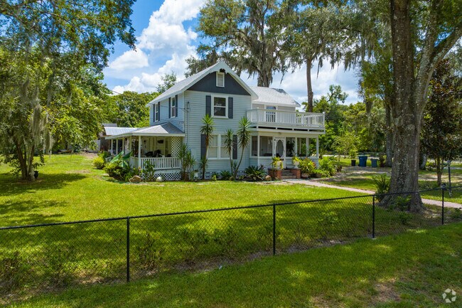 A large home with a well maintained fenced lawn in Deleon Springs.