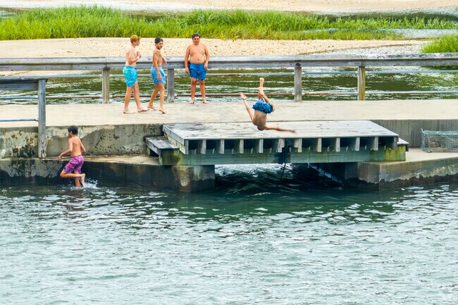 Front flip off the dock at The Sluice in Eaton's Neck, featuring natural swimming holes.
