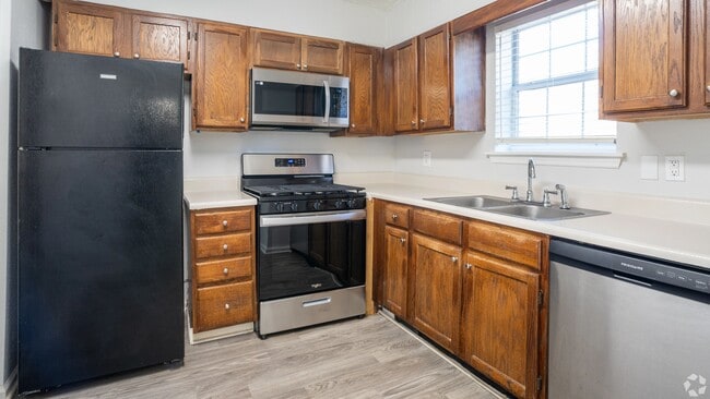 Spacious kitchen in The Roswell floor plan featuring modern appliances, ample cabinetry, and a double sink for convenience.