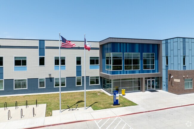 Idea Edgecliff College Preparatory is marked by flagpoles displaying the U.S. and Texas flags.
