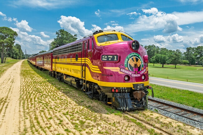 The Carolina Route train rolls through Pinehurst, offering scenic railway adventures.
