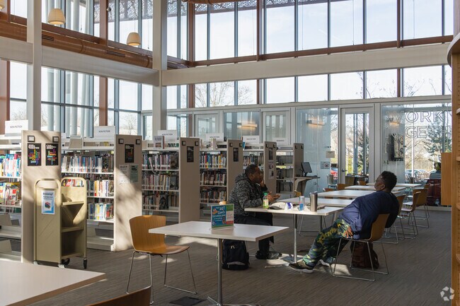 Walk through rows of books at the Route 9 Library & Innovation Center in Minquadale.