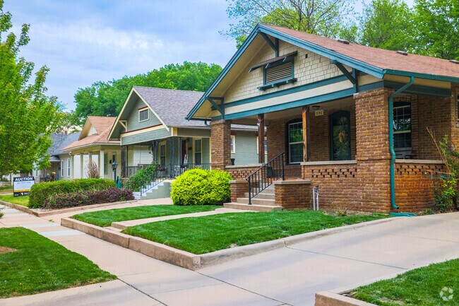 Row of homes with beautiful lawns and entry ways in Uptown Wichita.