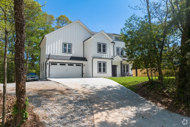 Newly built traditional homes sit back on wooded lots with simple landscaping.
